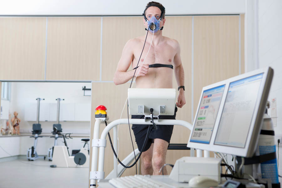 man on a treadmill and connected to medical monitoring equipment